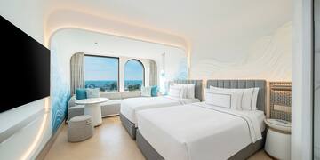 a room with two beds and a table