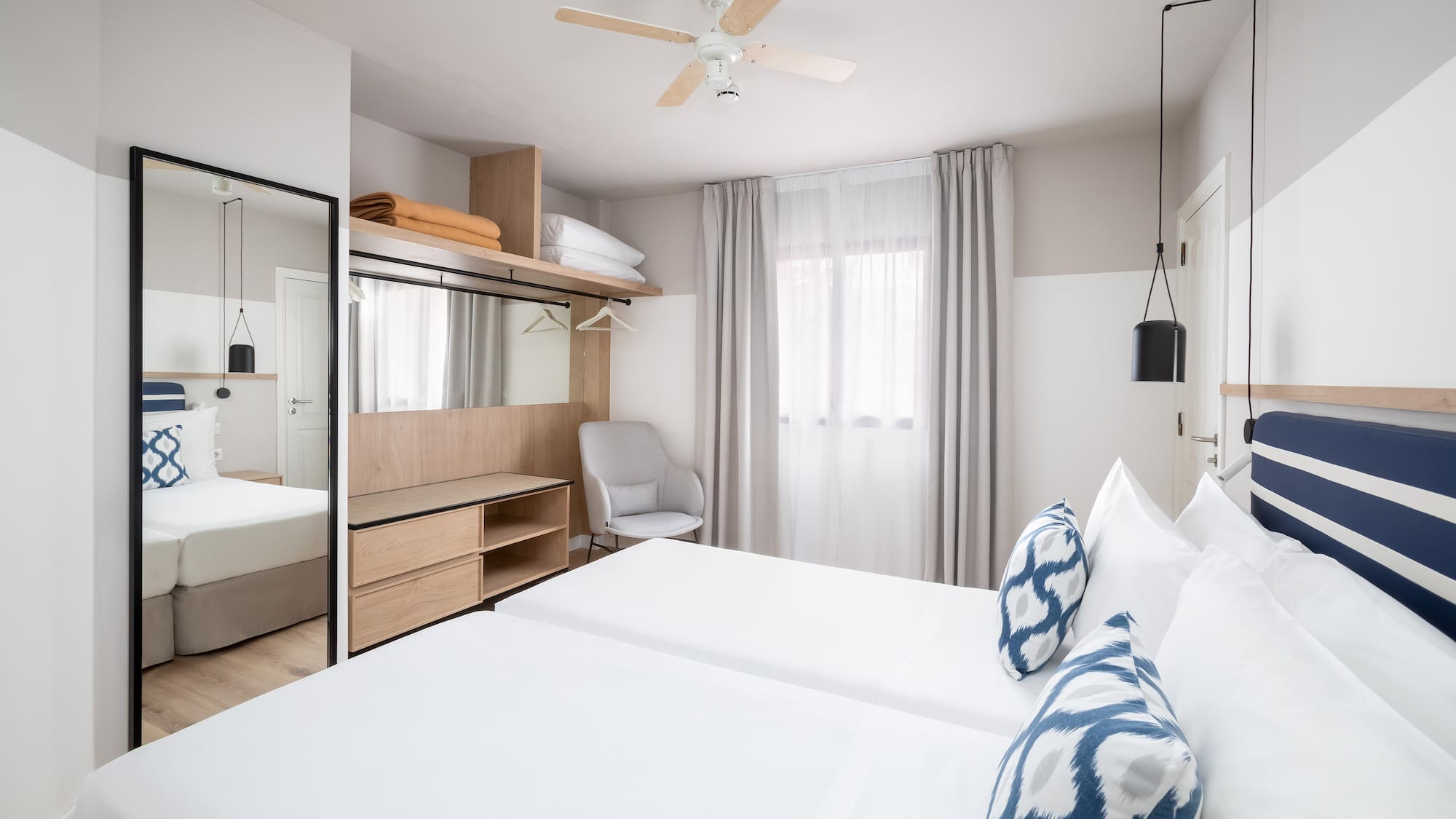 a room with a bed and a mirror