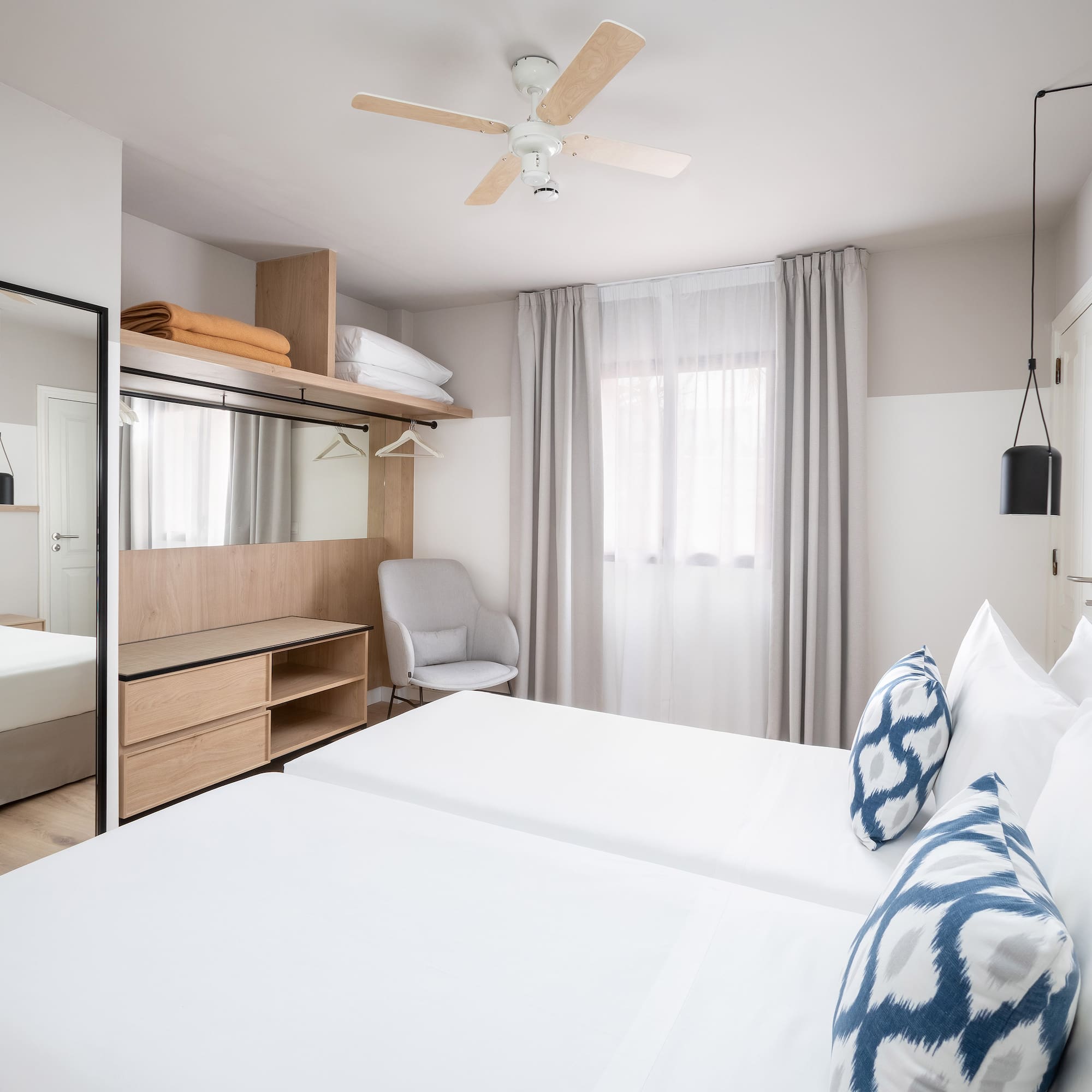 a room with a bed and a mirror