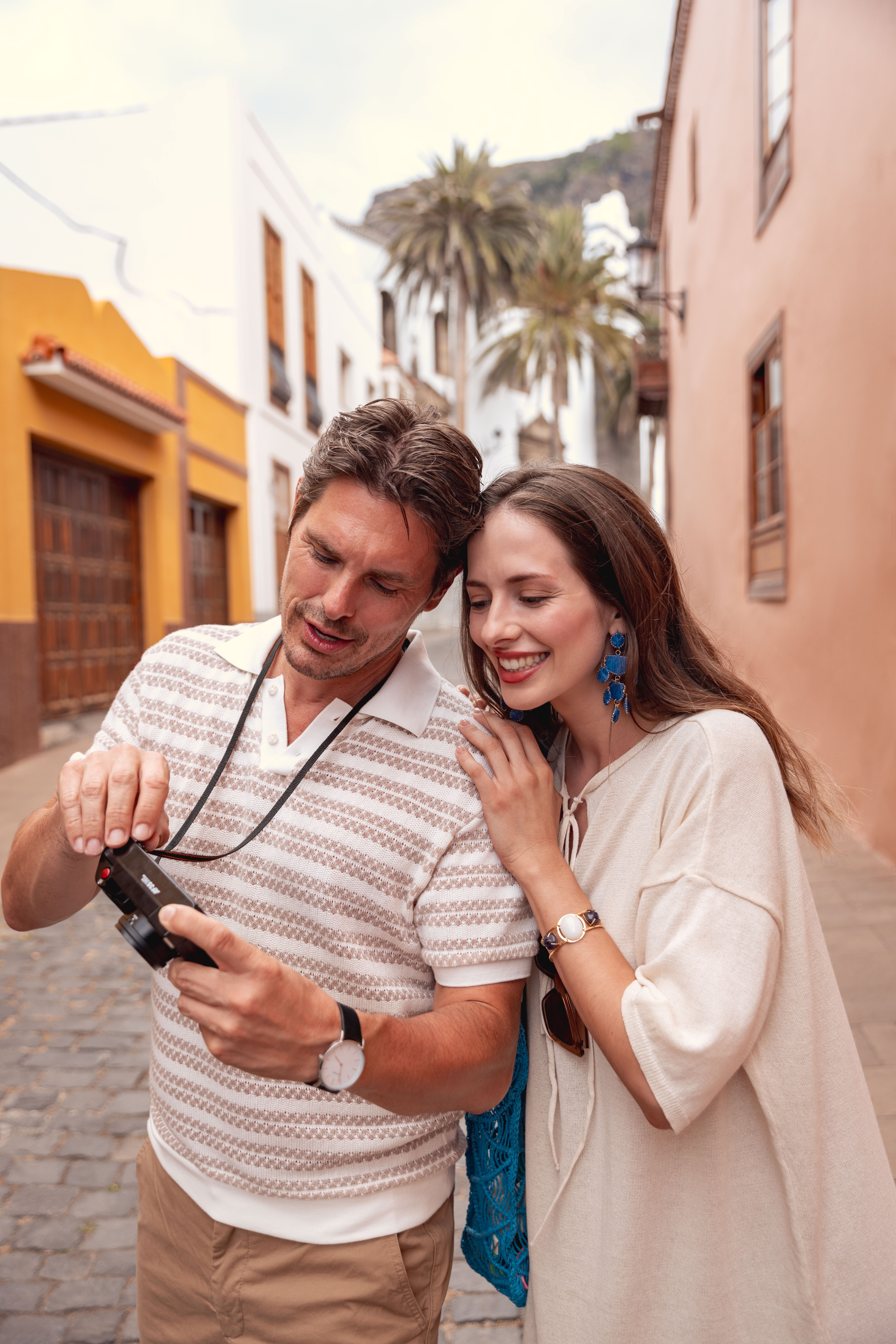 a man and woman looking at a camera