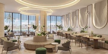 a room with a round table and chairs