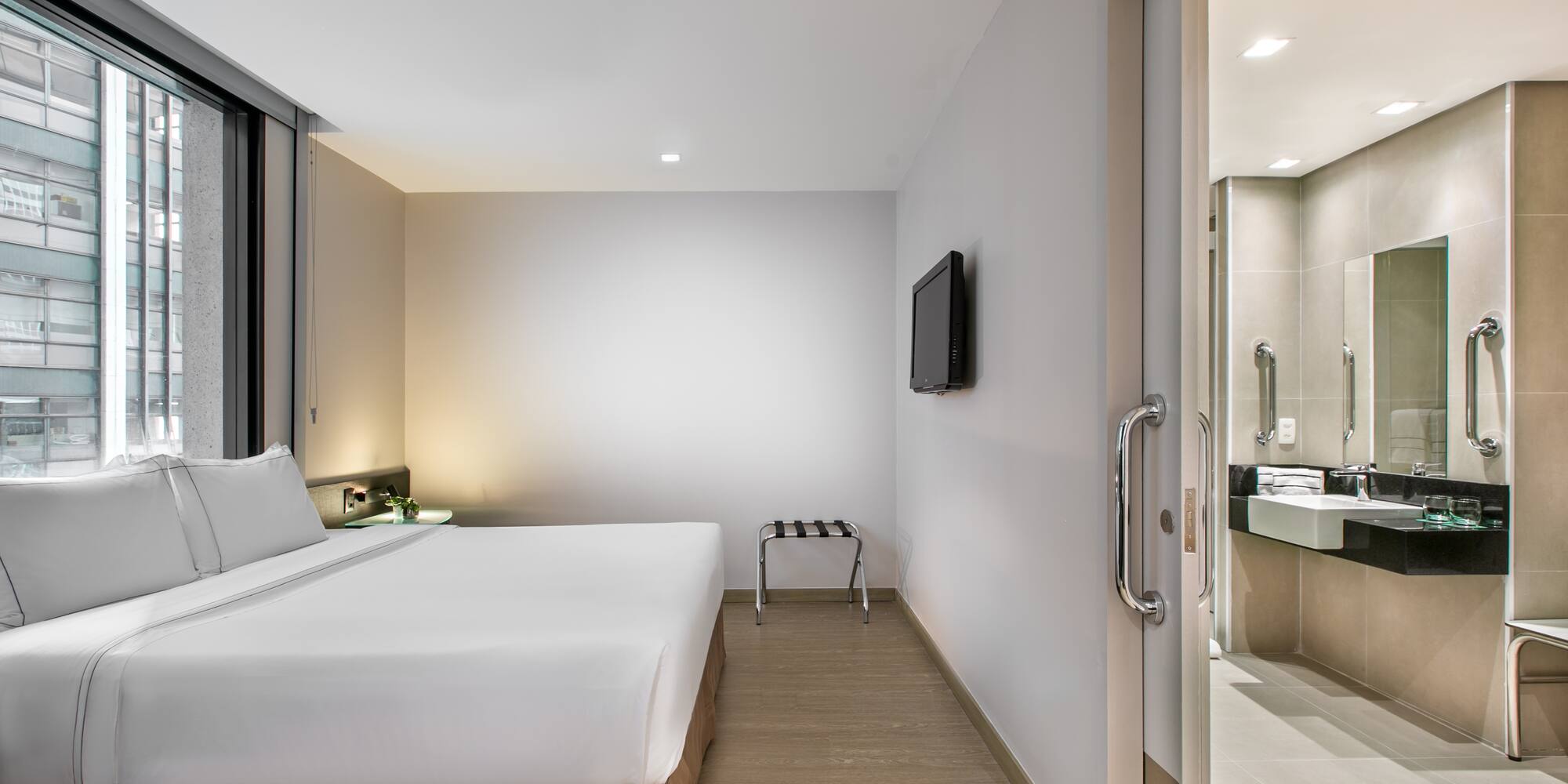 a room with a bed and a television