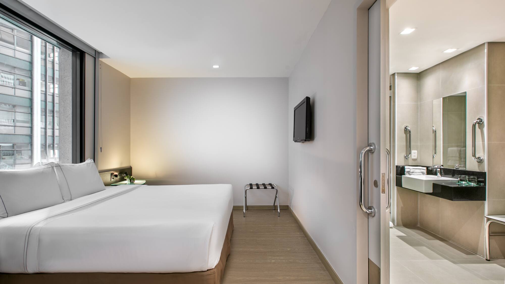 a room with a bed and a television