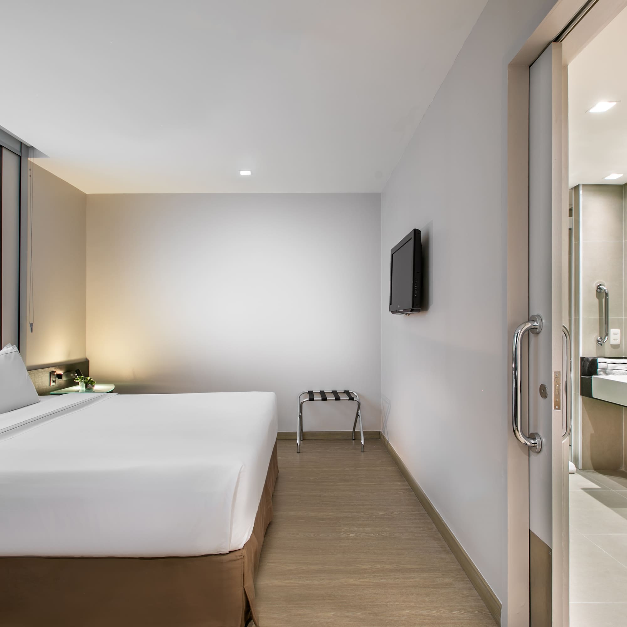 a room with a bed and a television