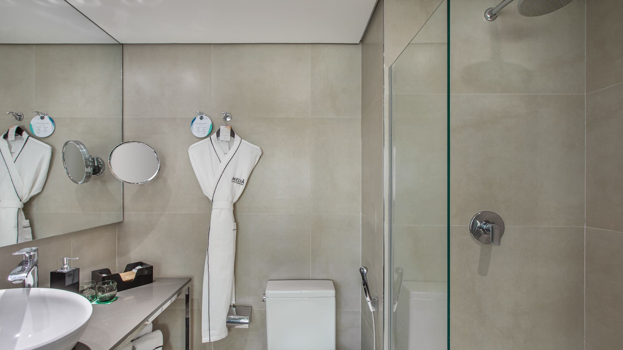 a bathroom with a white robe and a shower