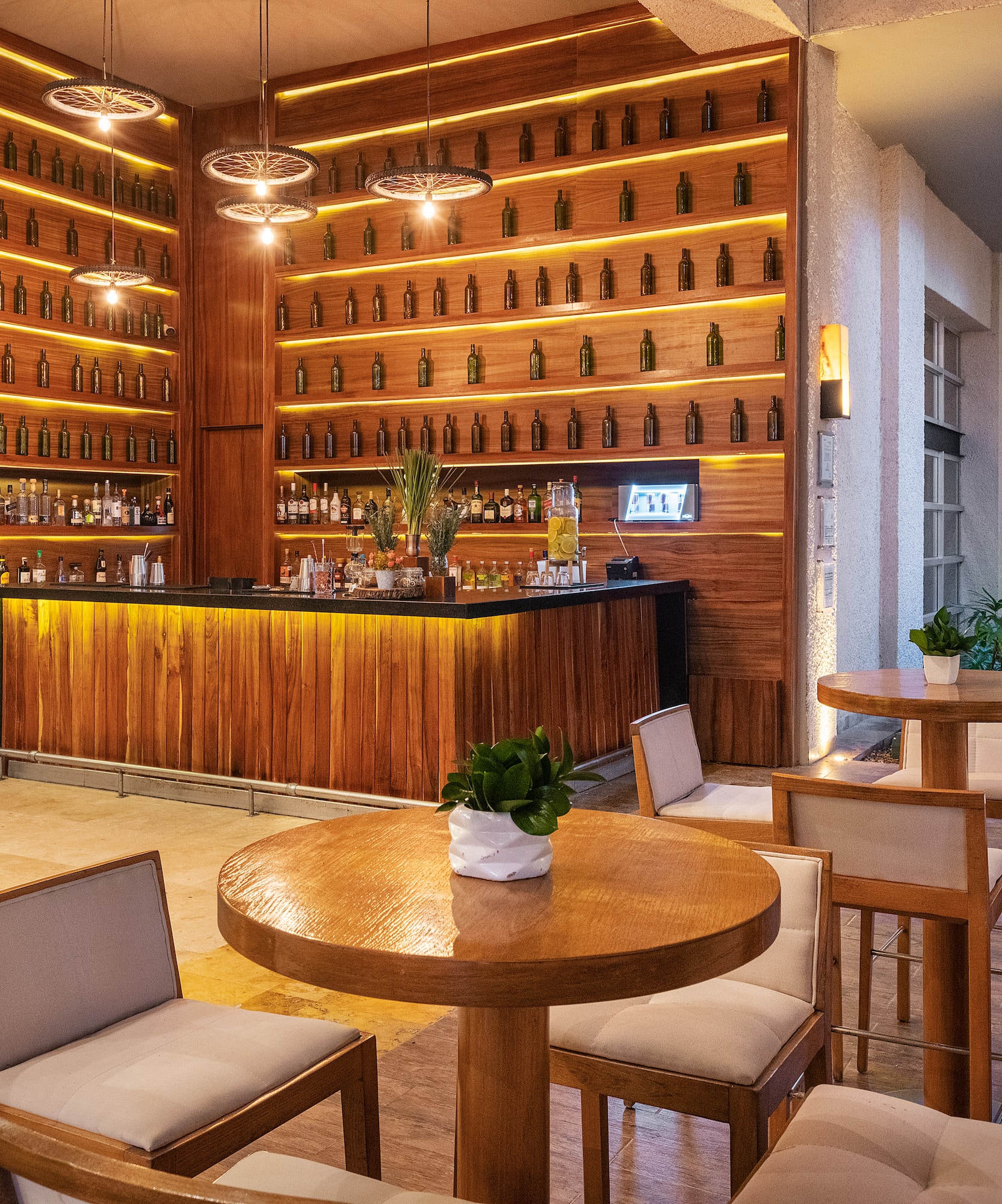 a room with a bar and a table and chairs