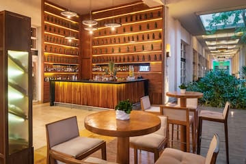 a room with a bar and a table and chairs