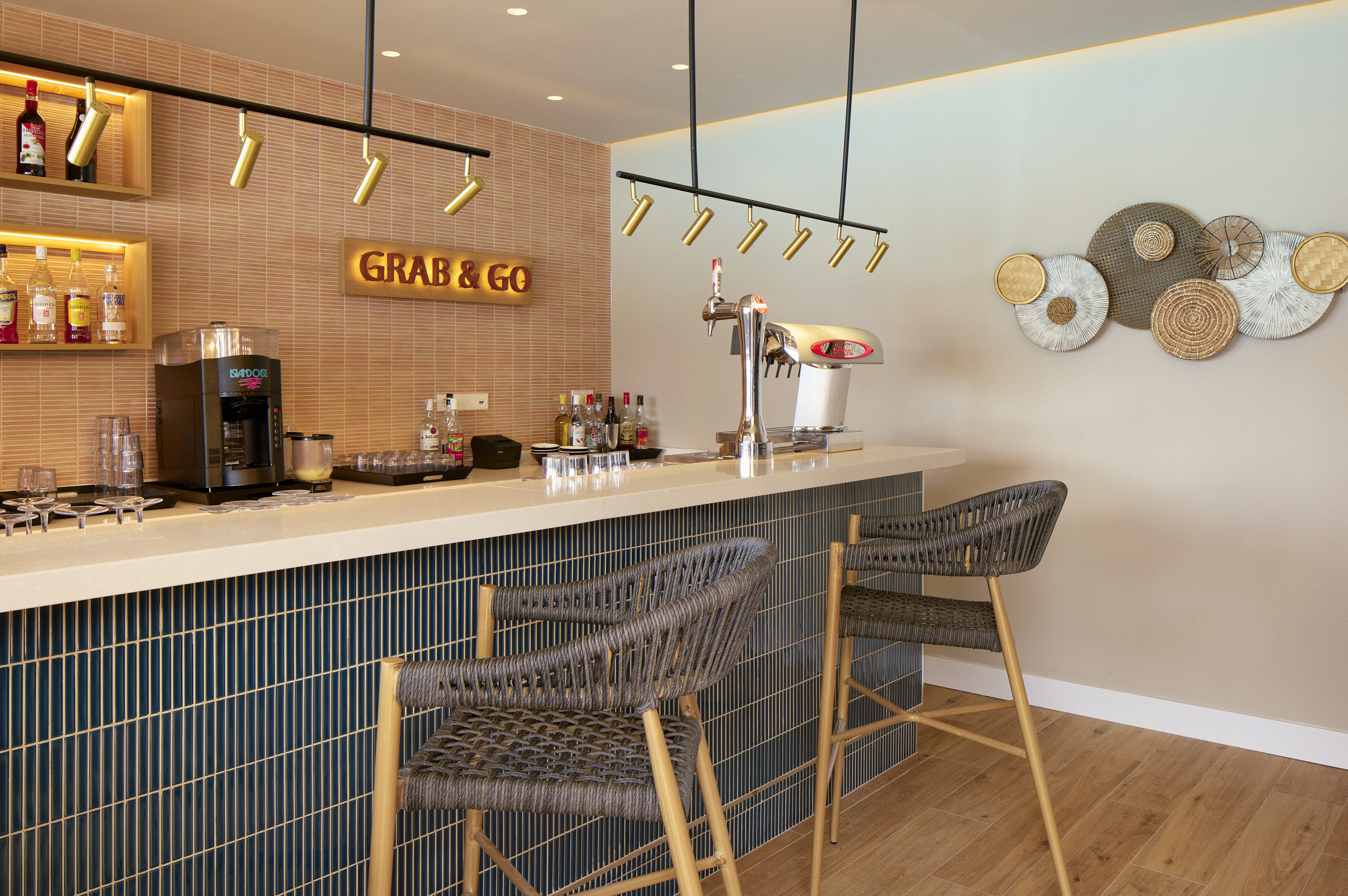 Grab & Go bar with beer tap, coffee machine, and woven bar stools.
