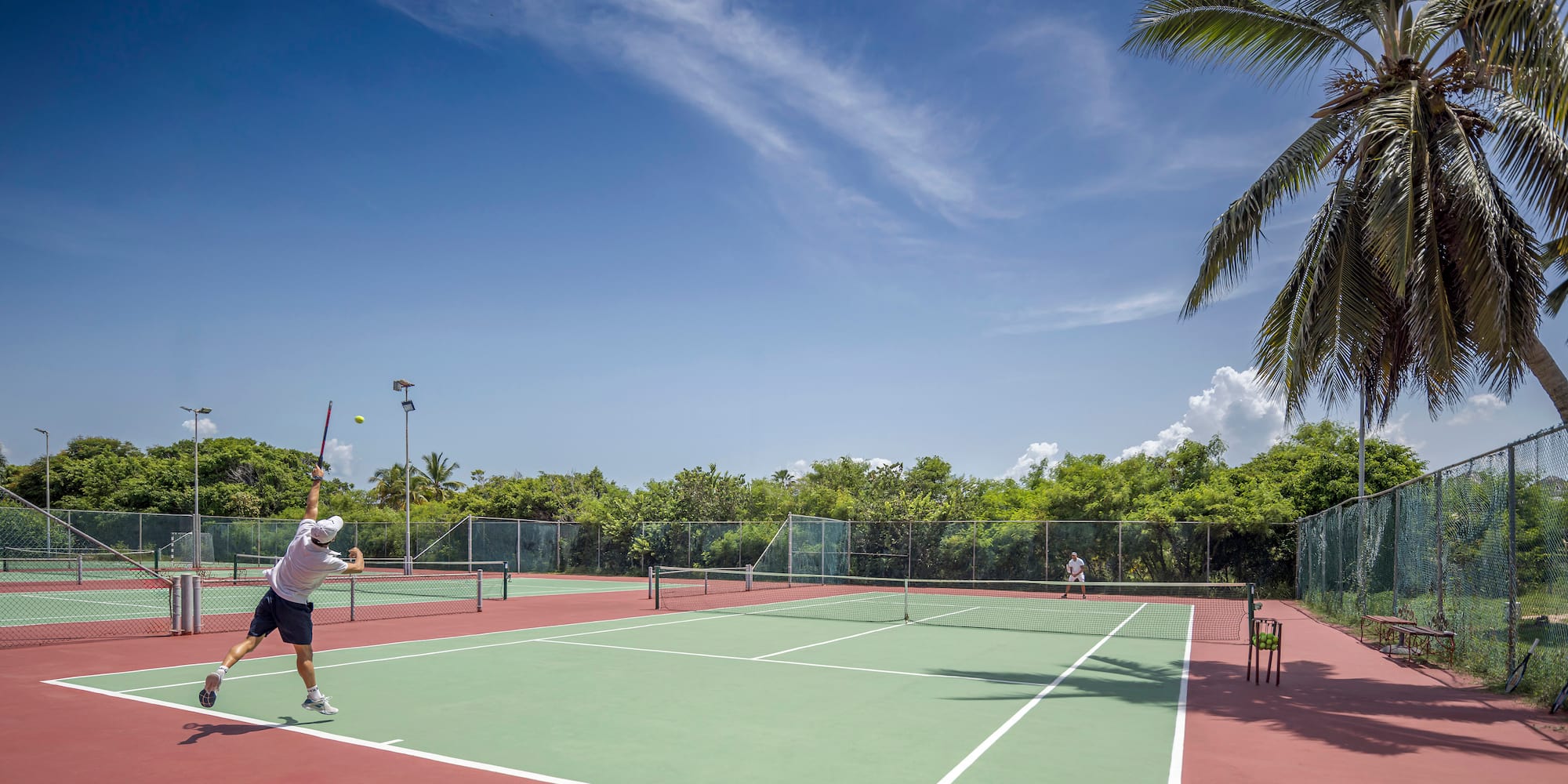 a man playing tennis on a tennis court