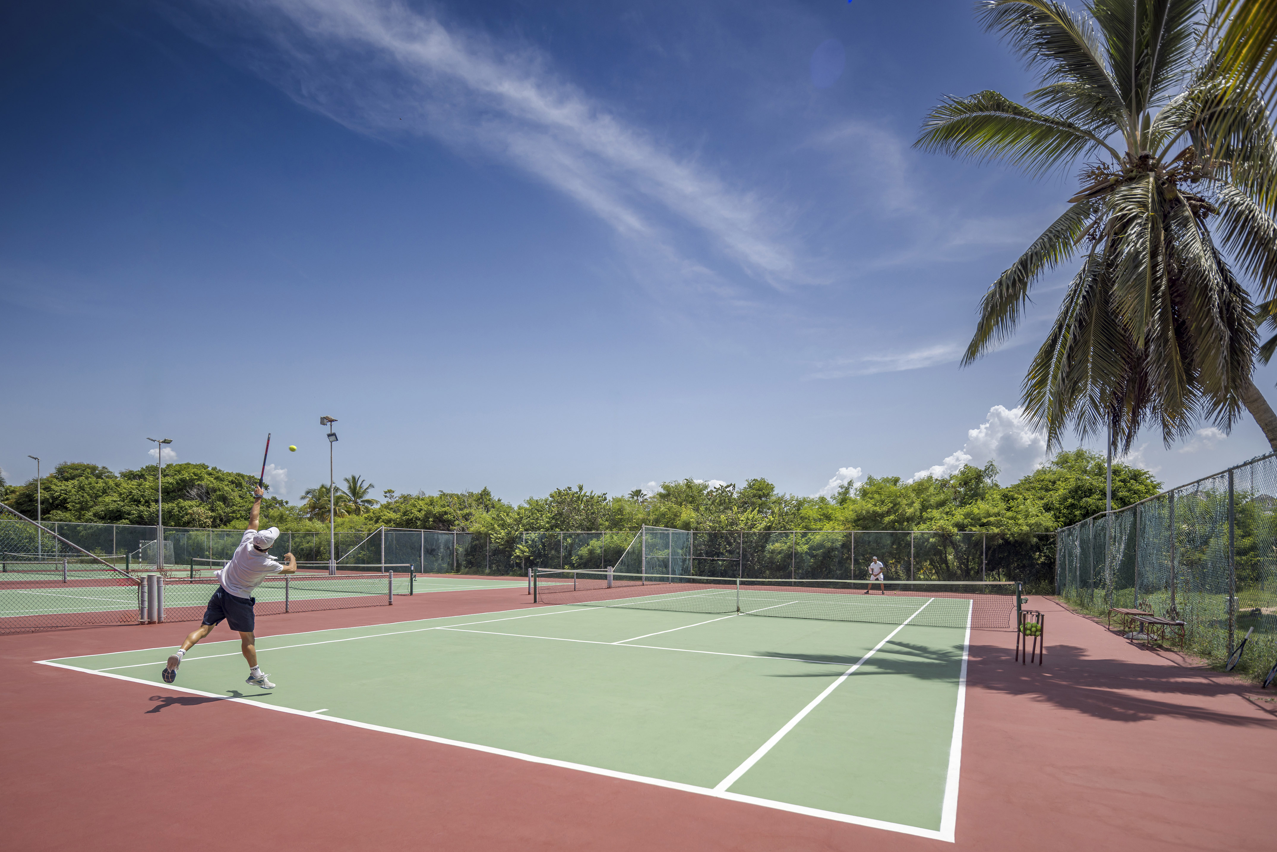 a man playing tennis on a tennis court