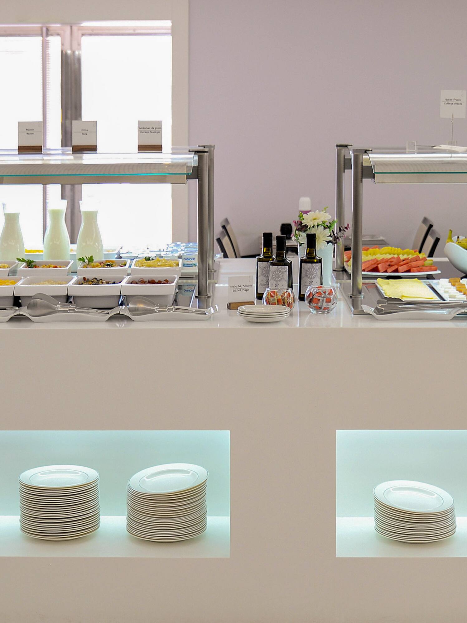 a buffet with plates and food on shelves