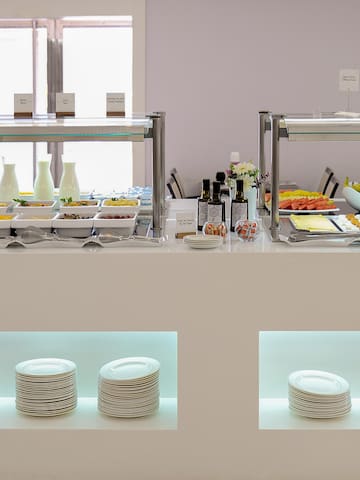 a buffet with plates and food on shelves