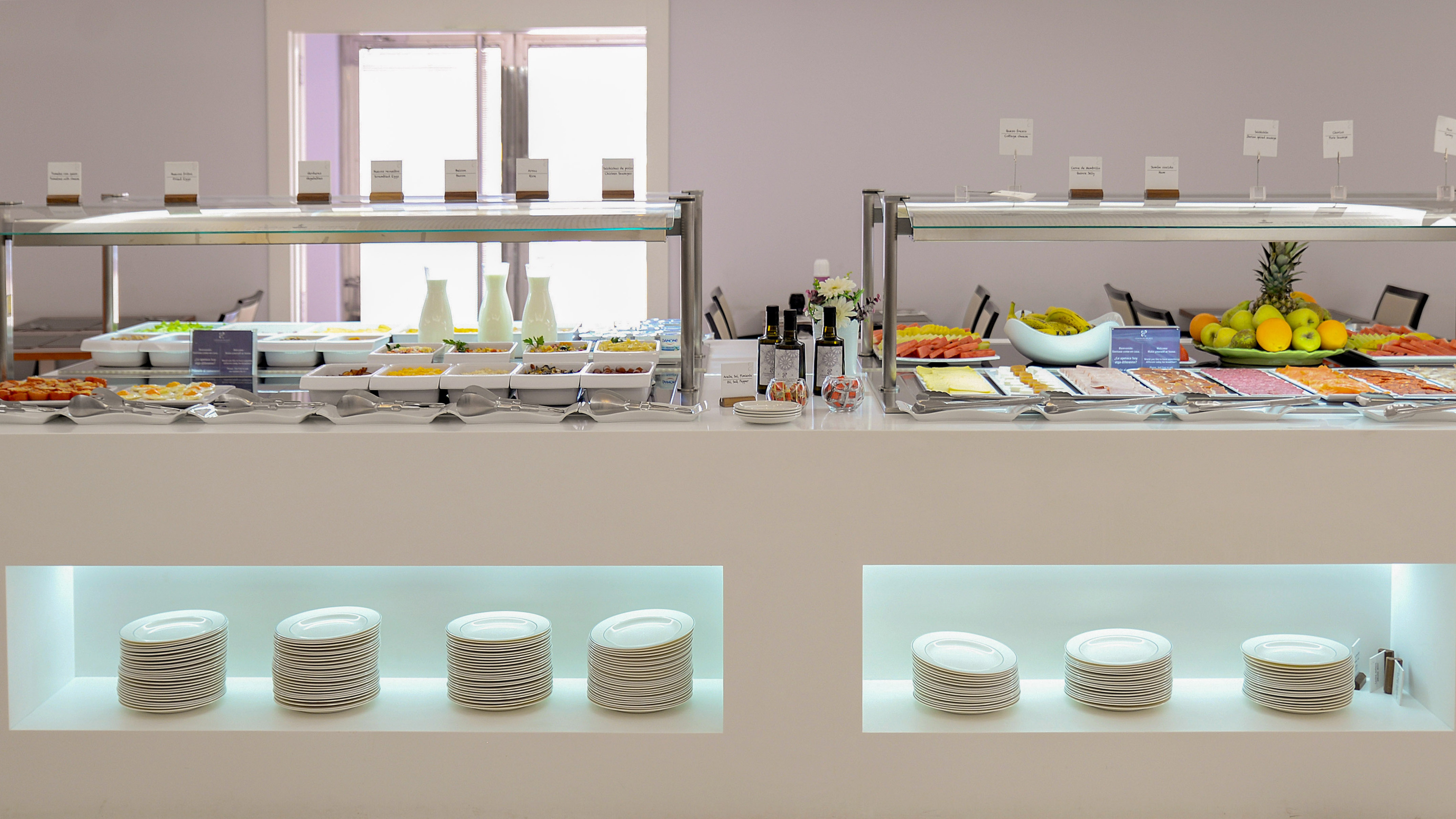 a buffet with plates and food on shelves