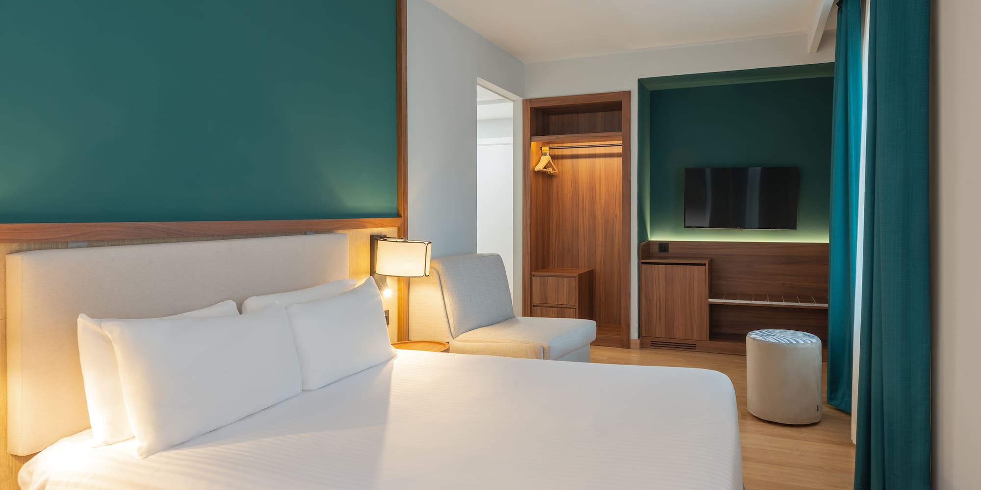 a room with a bed and a tv