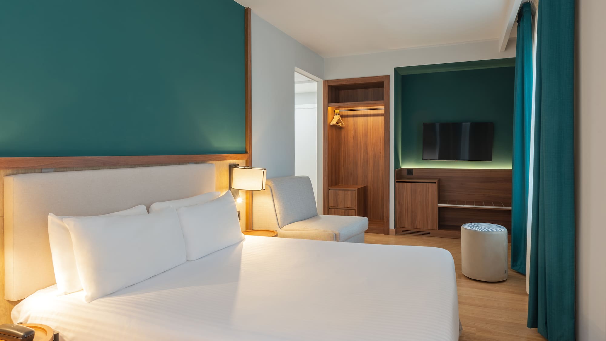 a room with a bed and a tv