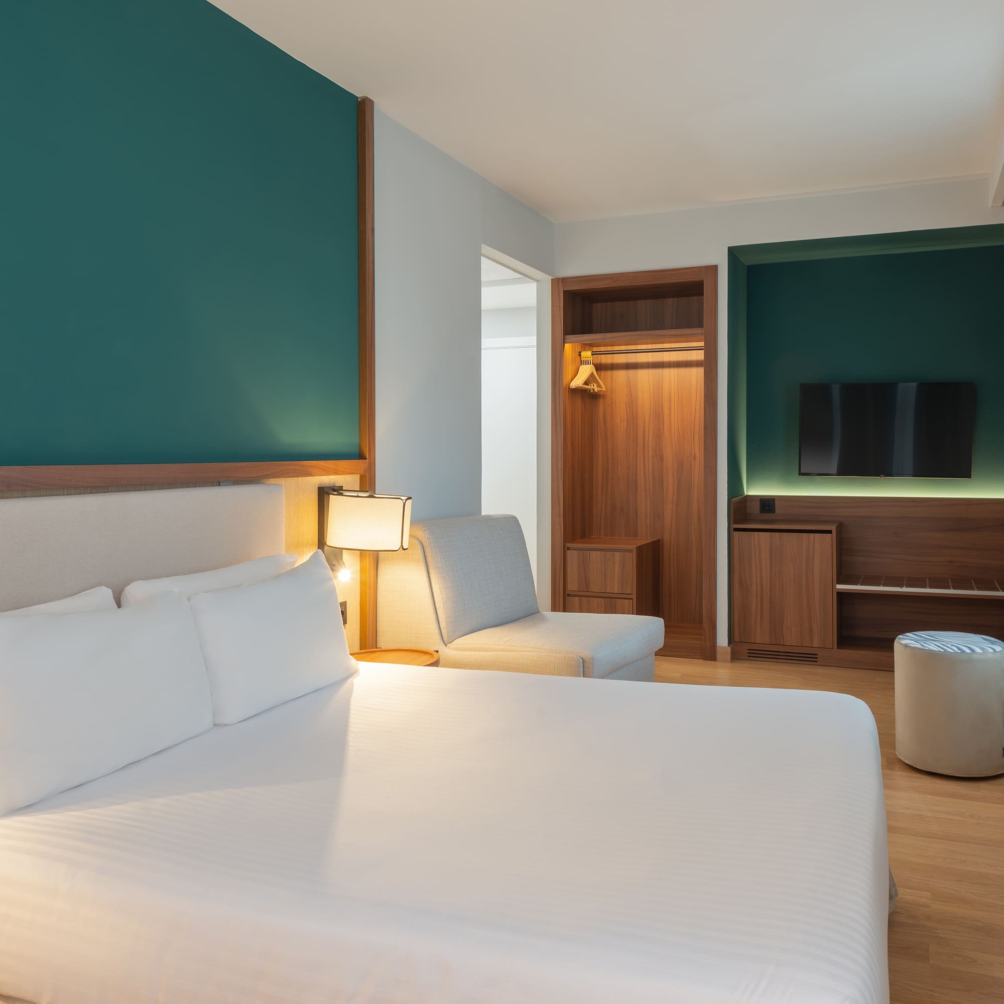 a room with a bed and a tv