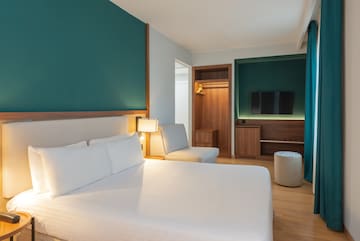 a room with a bed and a tv