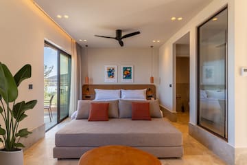 a bedroom with a bed and a ceiling fan