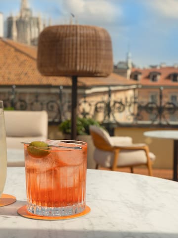 a glass of liquid and a drink on a table