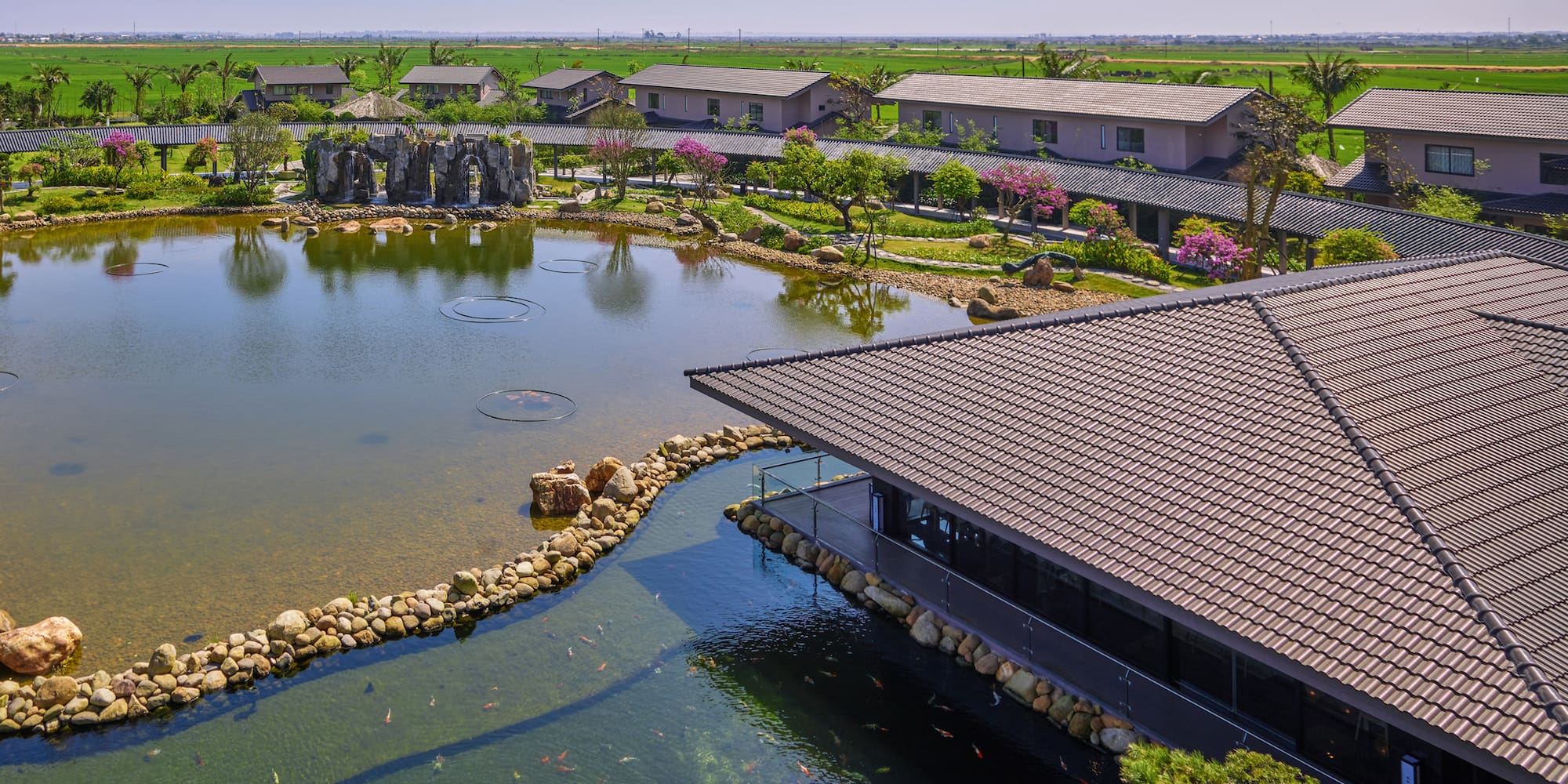 a pond with a building and a pond with a pond in the background