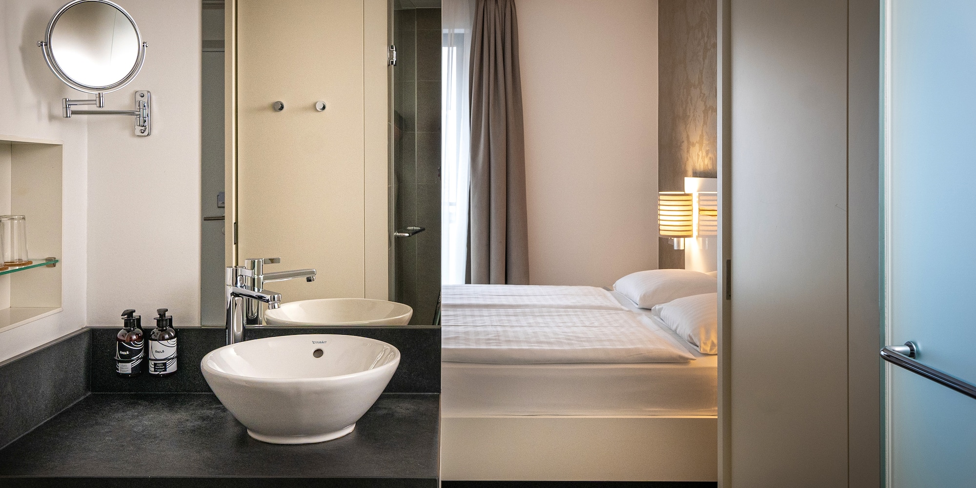 a bathroom with a bed and sink