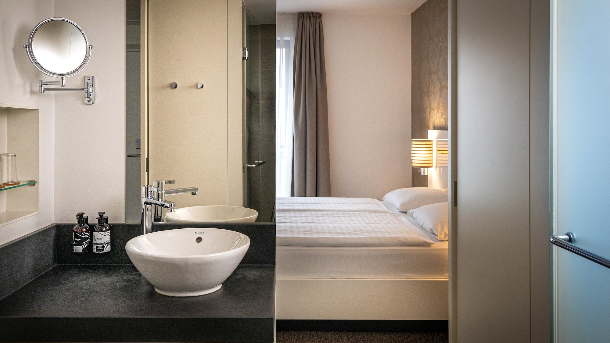 a bathroom with a bed and sink