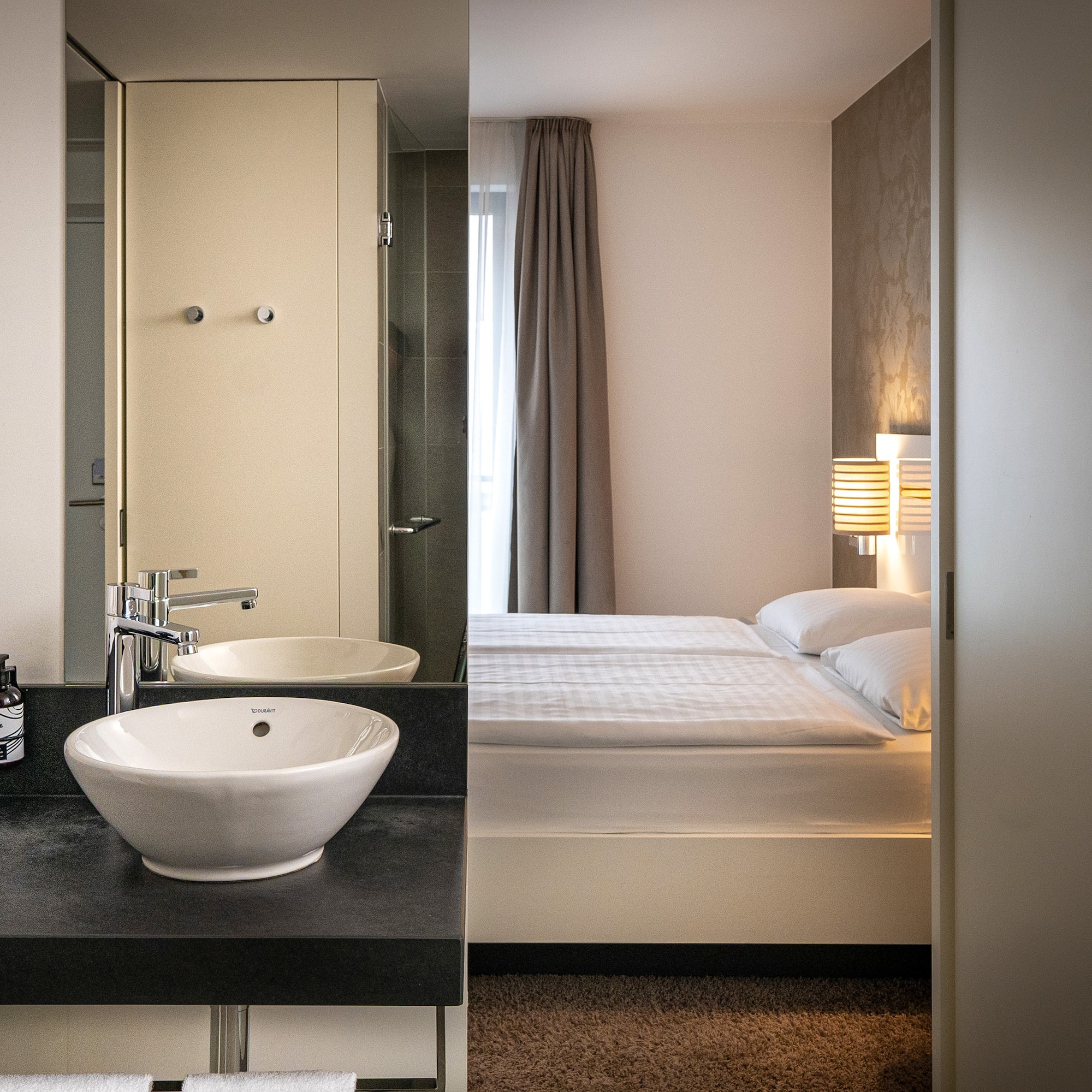 a bathroom with a bed and sink