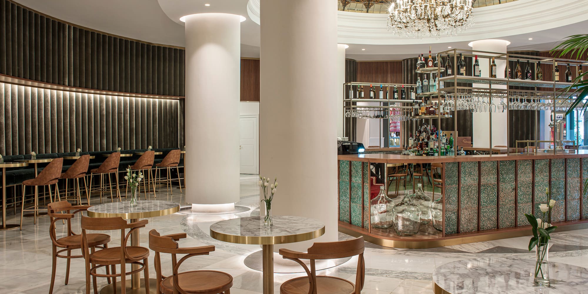 a room with a bar and tables