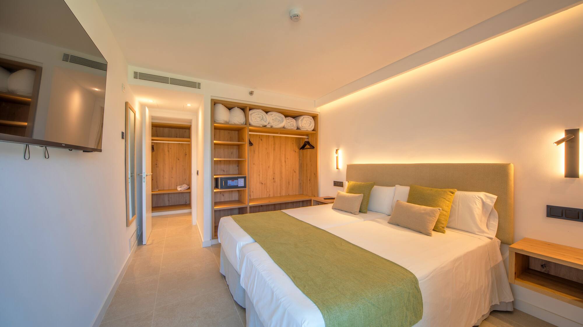 a room with a bed and shelves