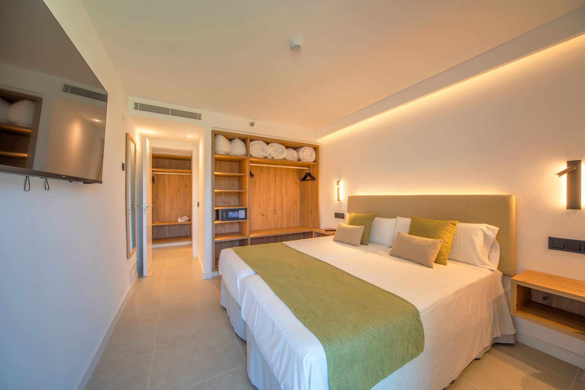 a room with a bed and shelves