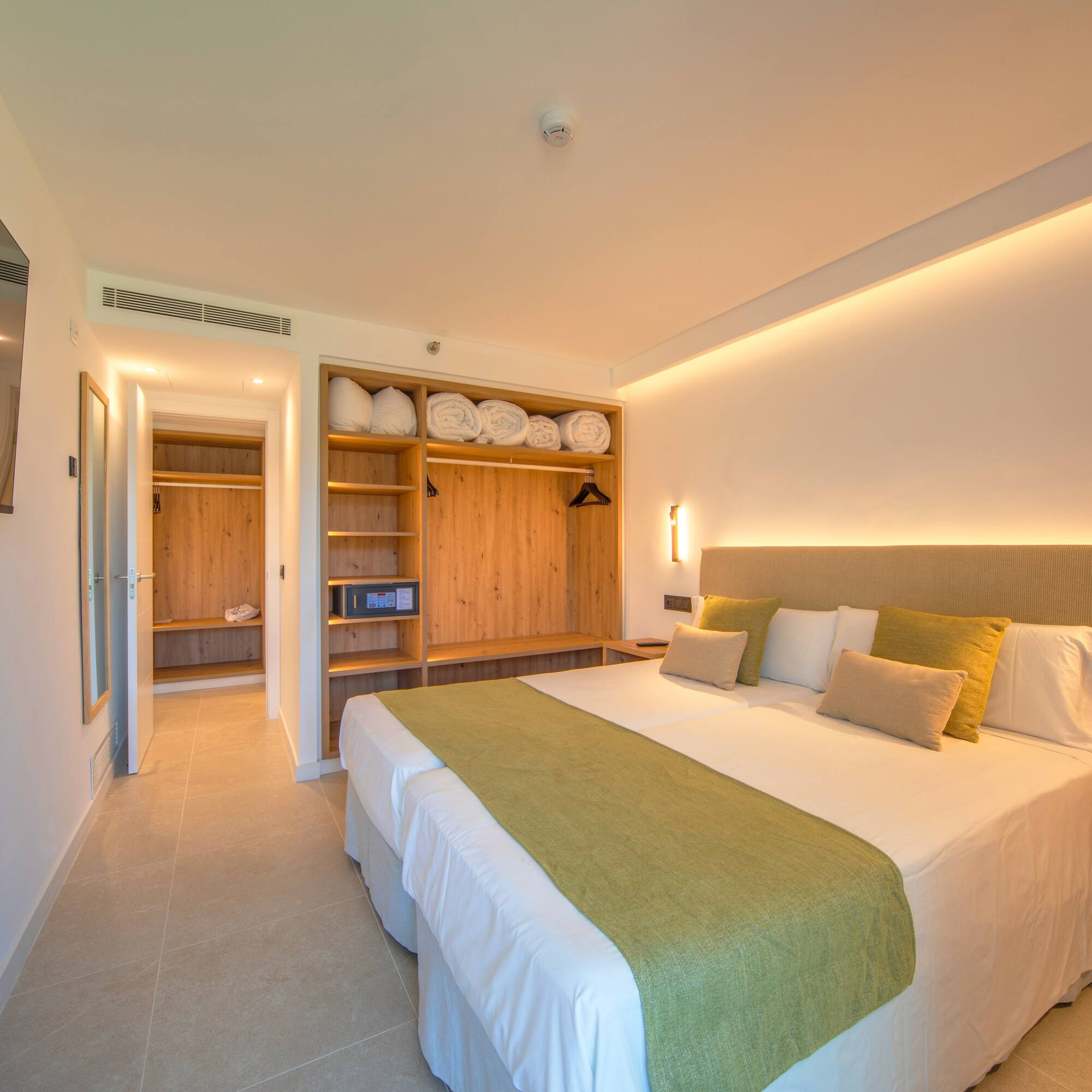 a room with a bed and shelves