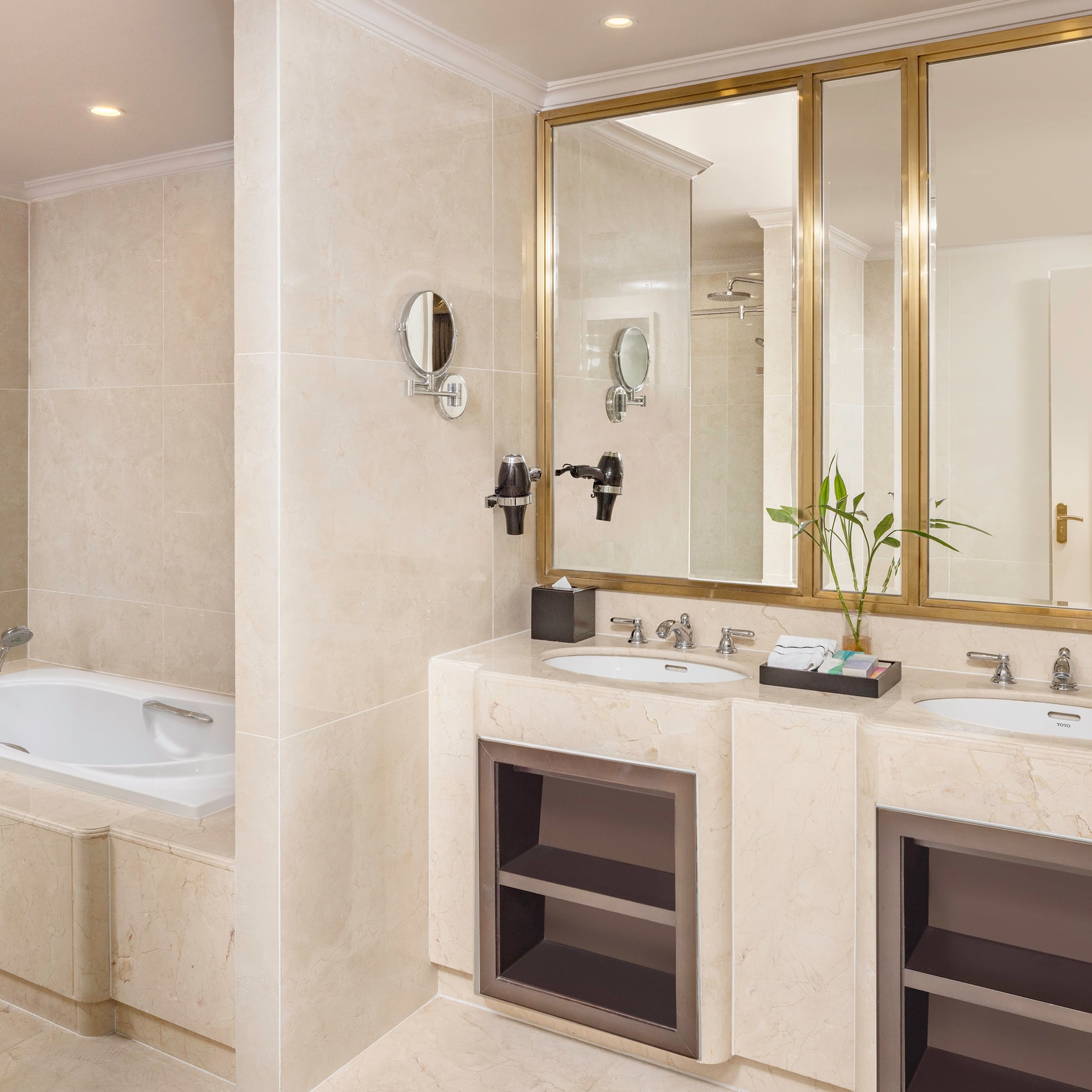 a bathroom with marble countertops and a bathtub