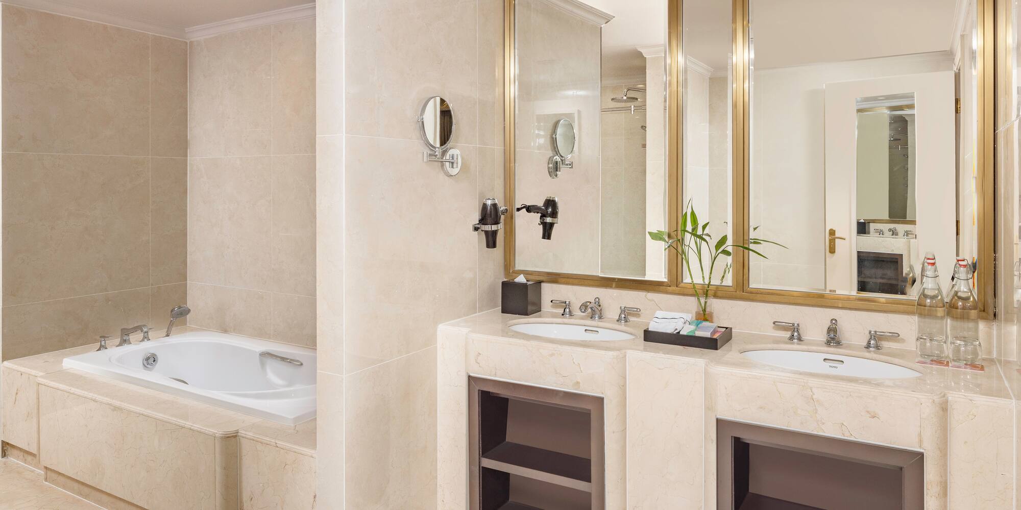 a bathroom with marble countertops and a bathtub