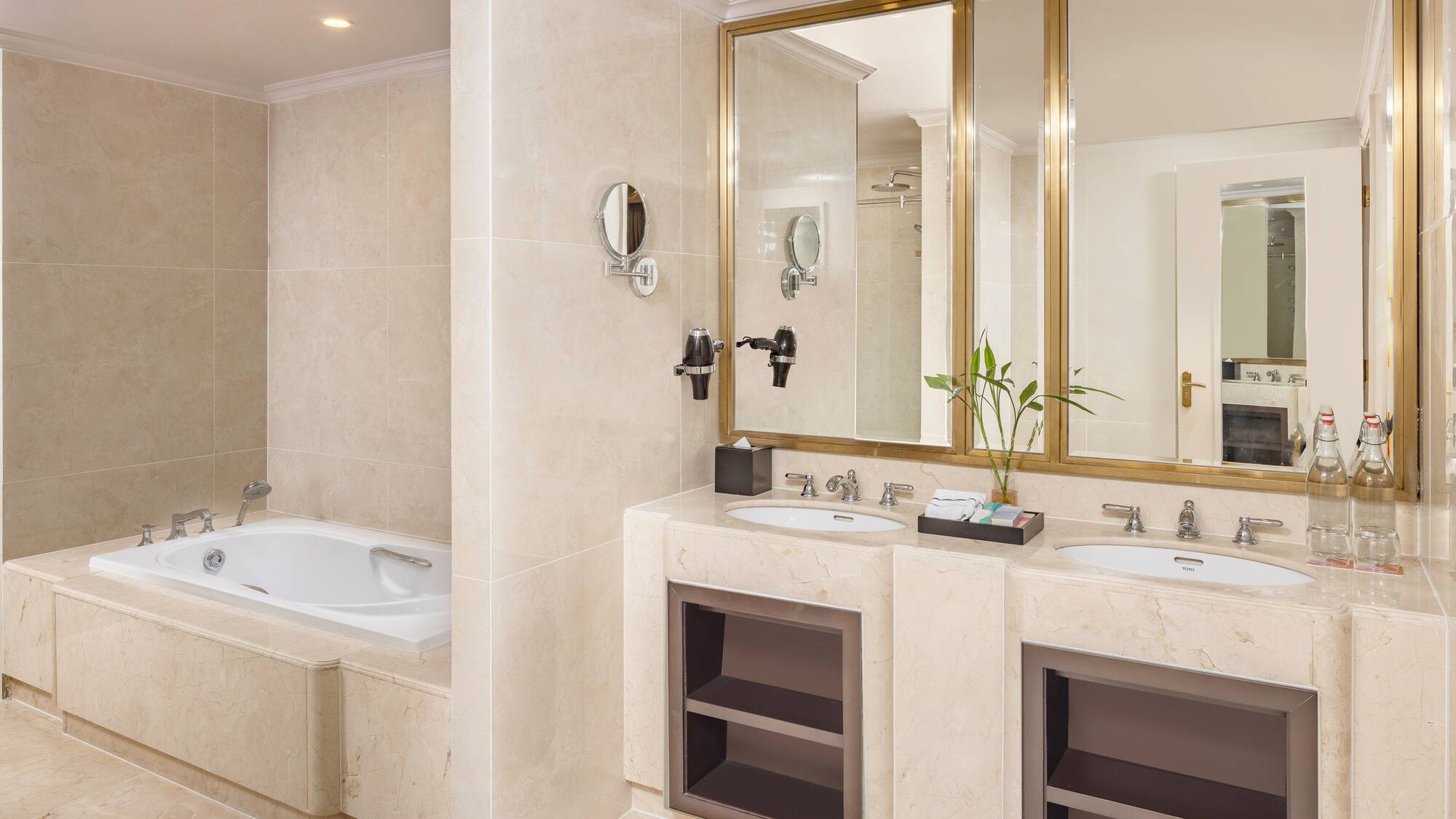 a bathroom with marble countertops and a bathtub