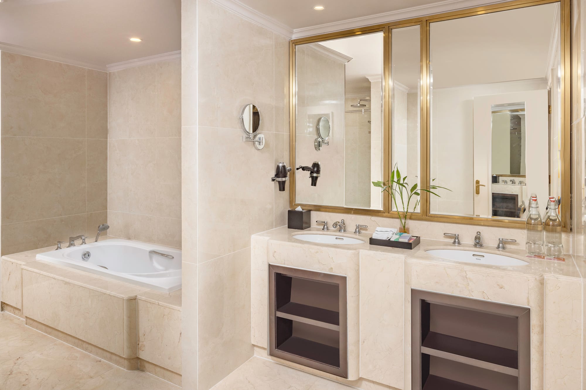 a bathroom with marble countertops and a bathtub