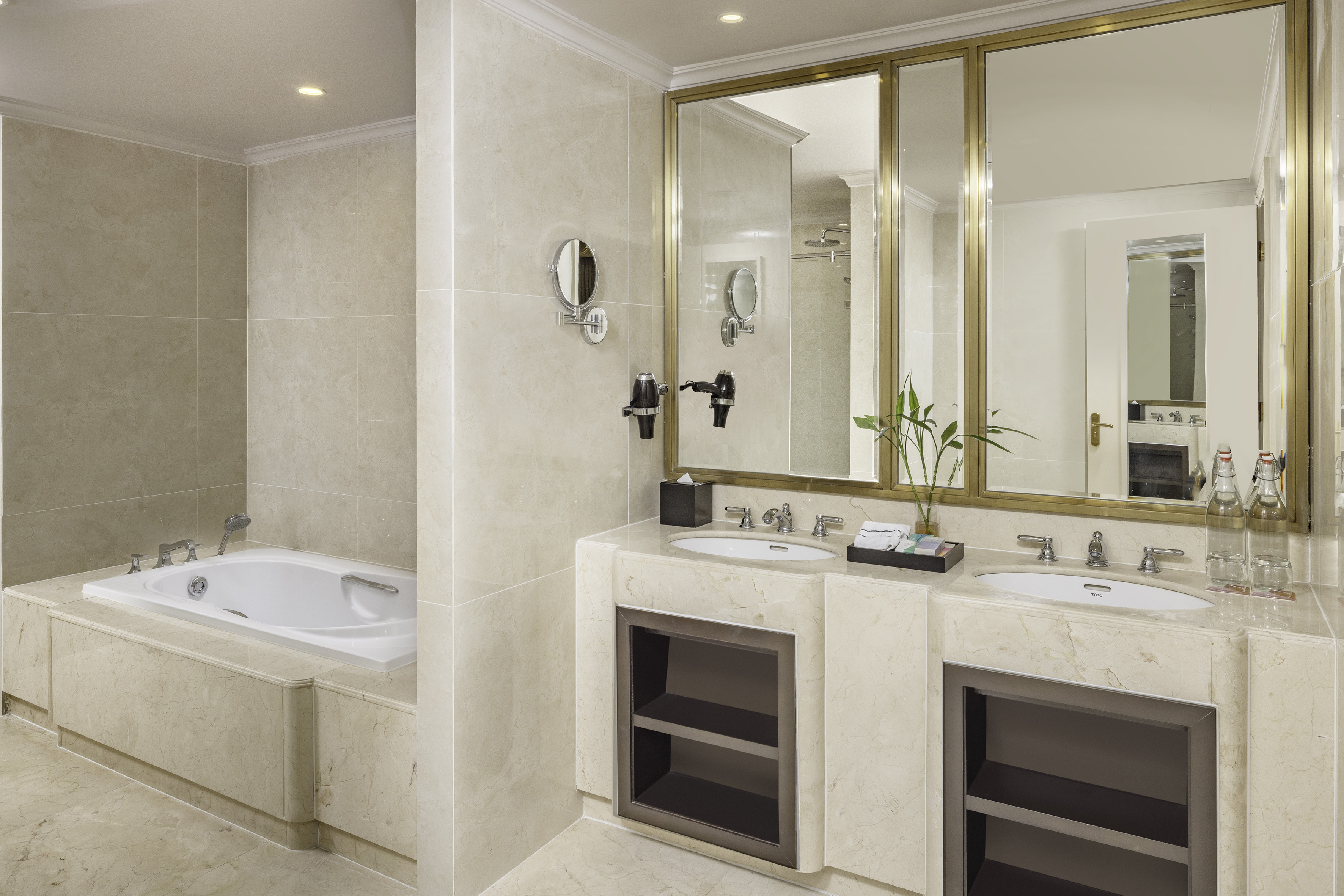 a bathroom with marble countertops and a bathtub