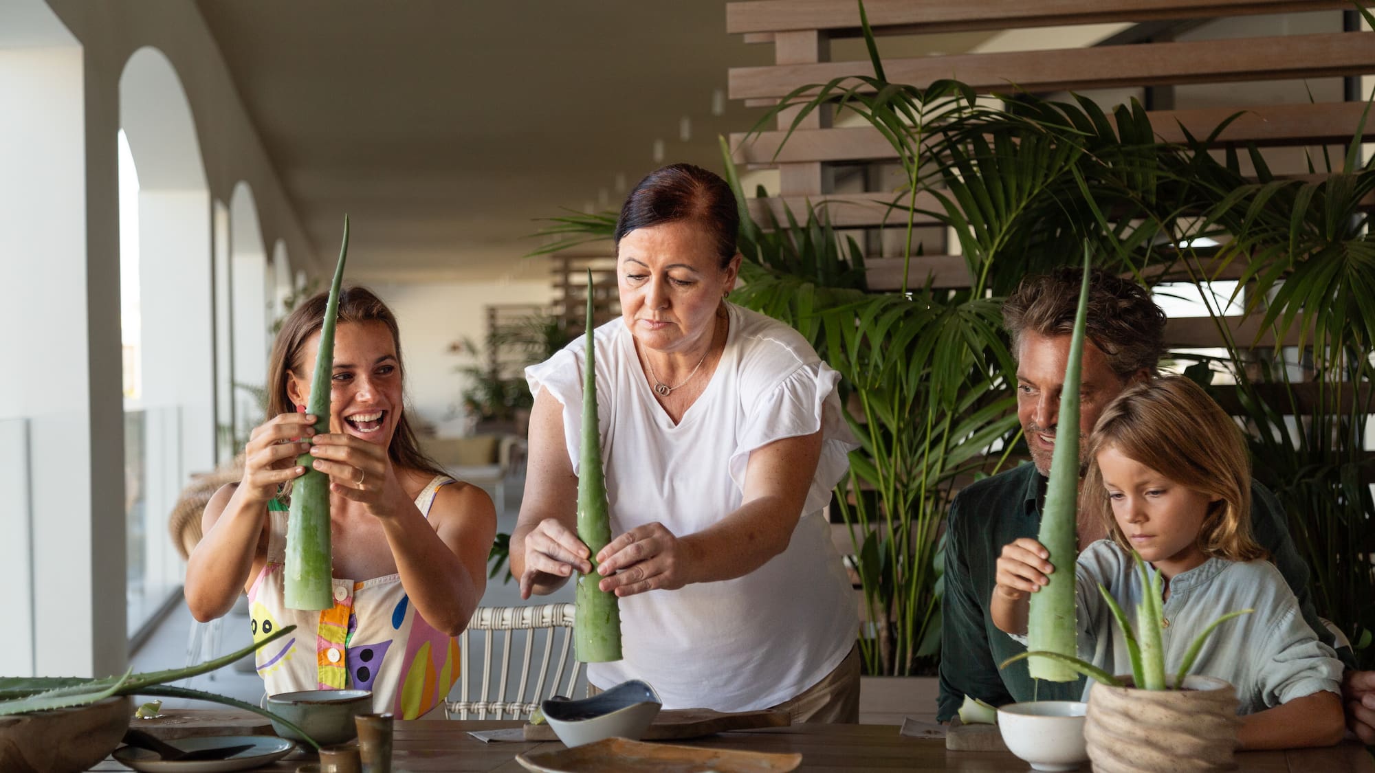 a group of people holding aloe vera