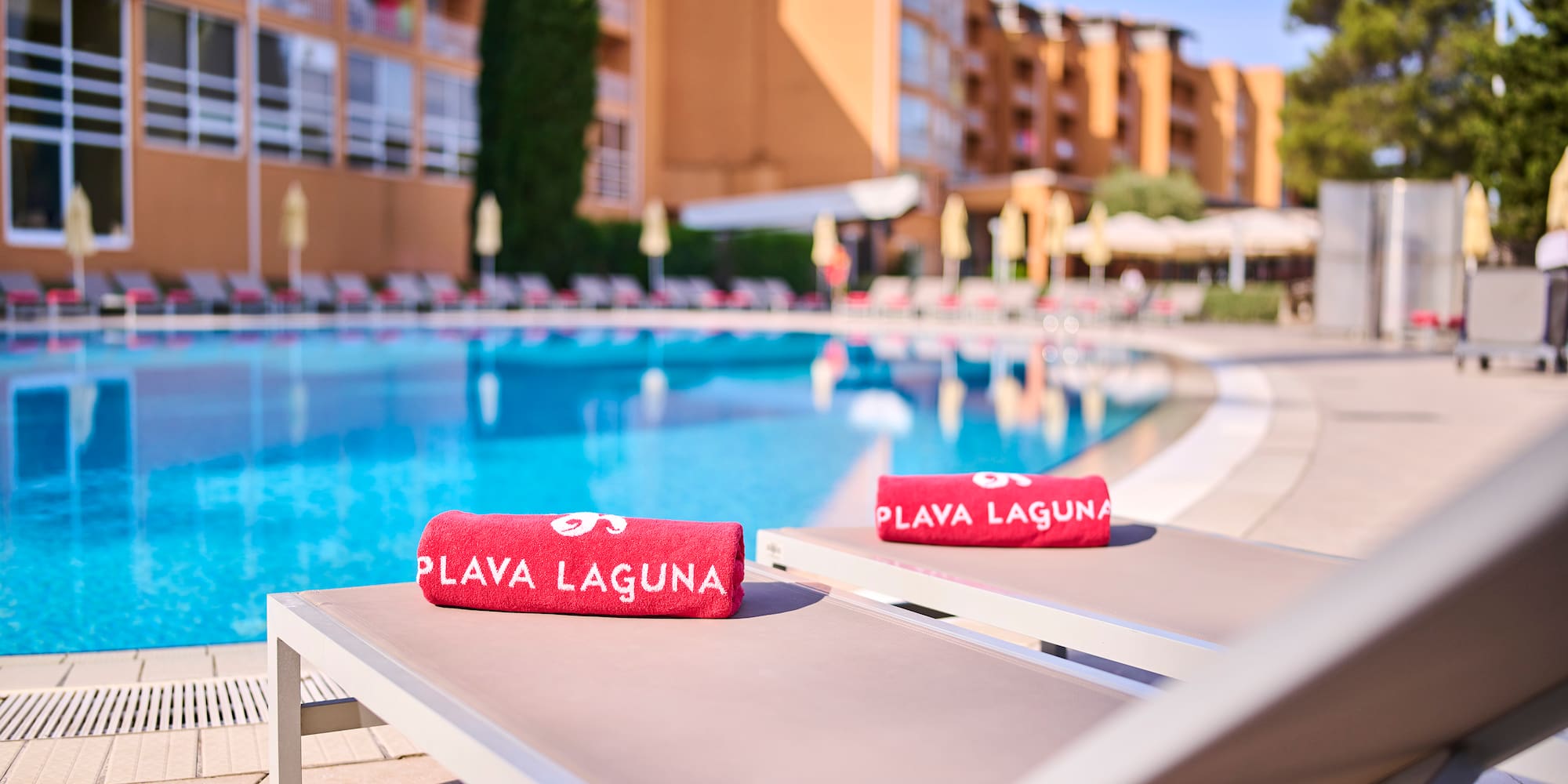 a pool with a lounge chair and towels