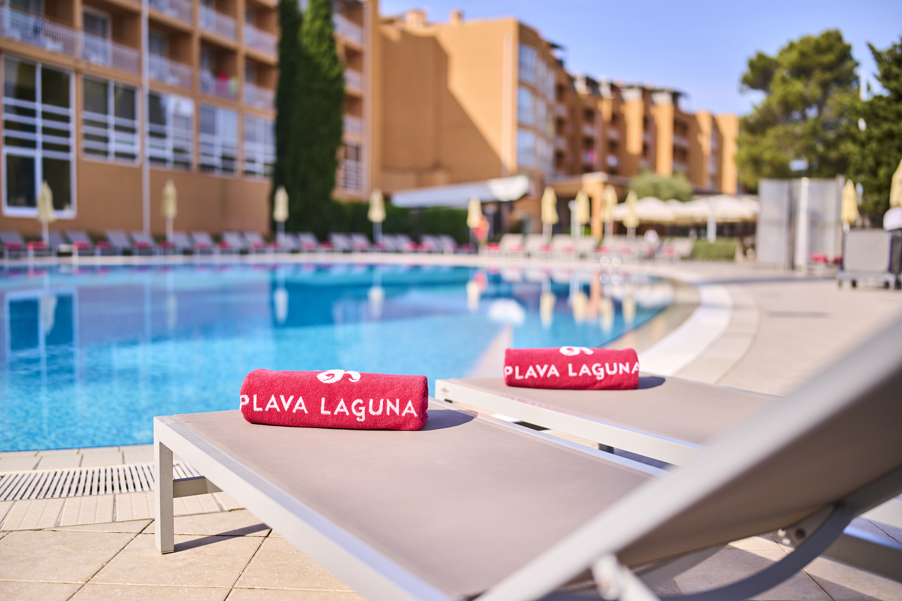 a pool with a lounge chair and towels