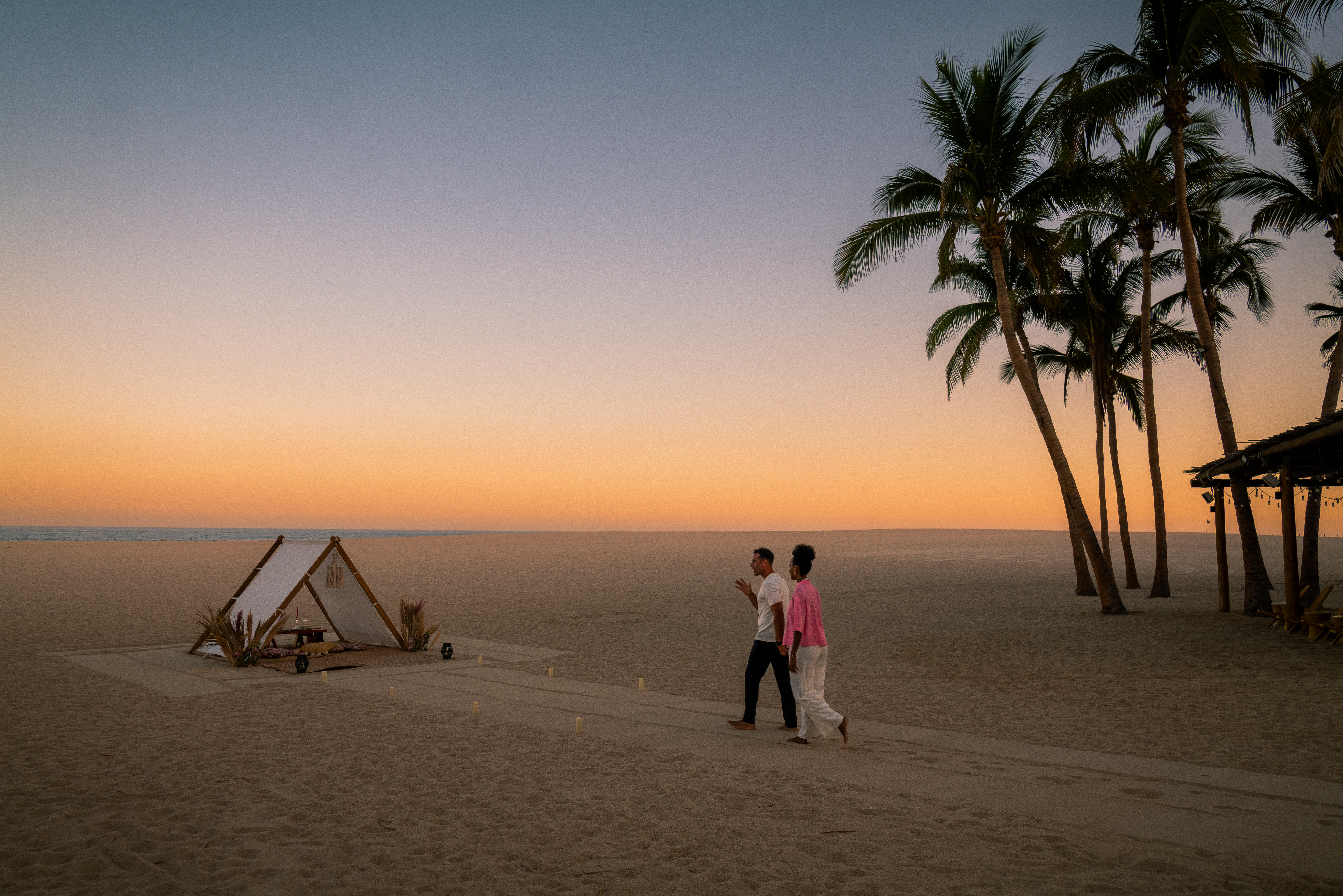 a couple walking on a beach