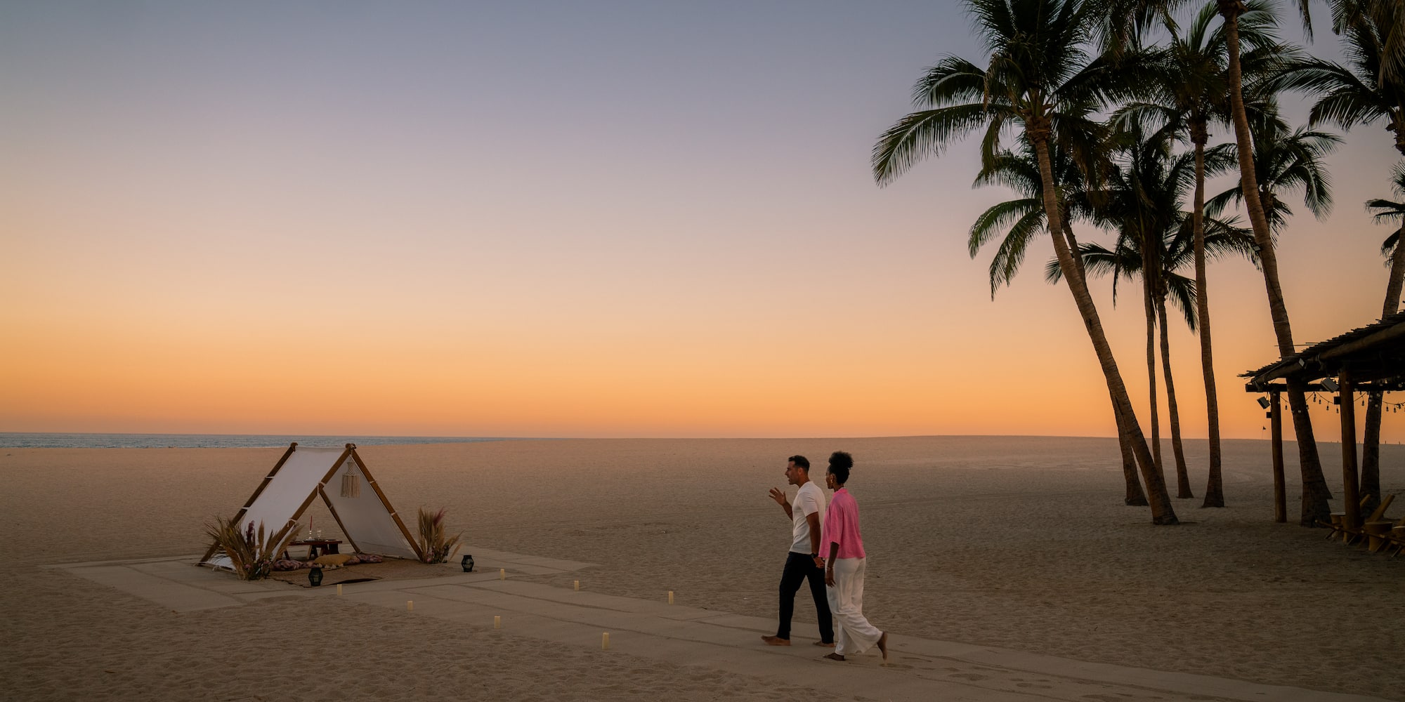 a couple walking on a beach