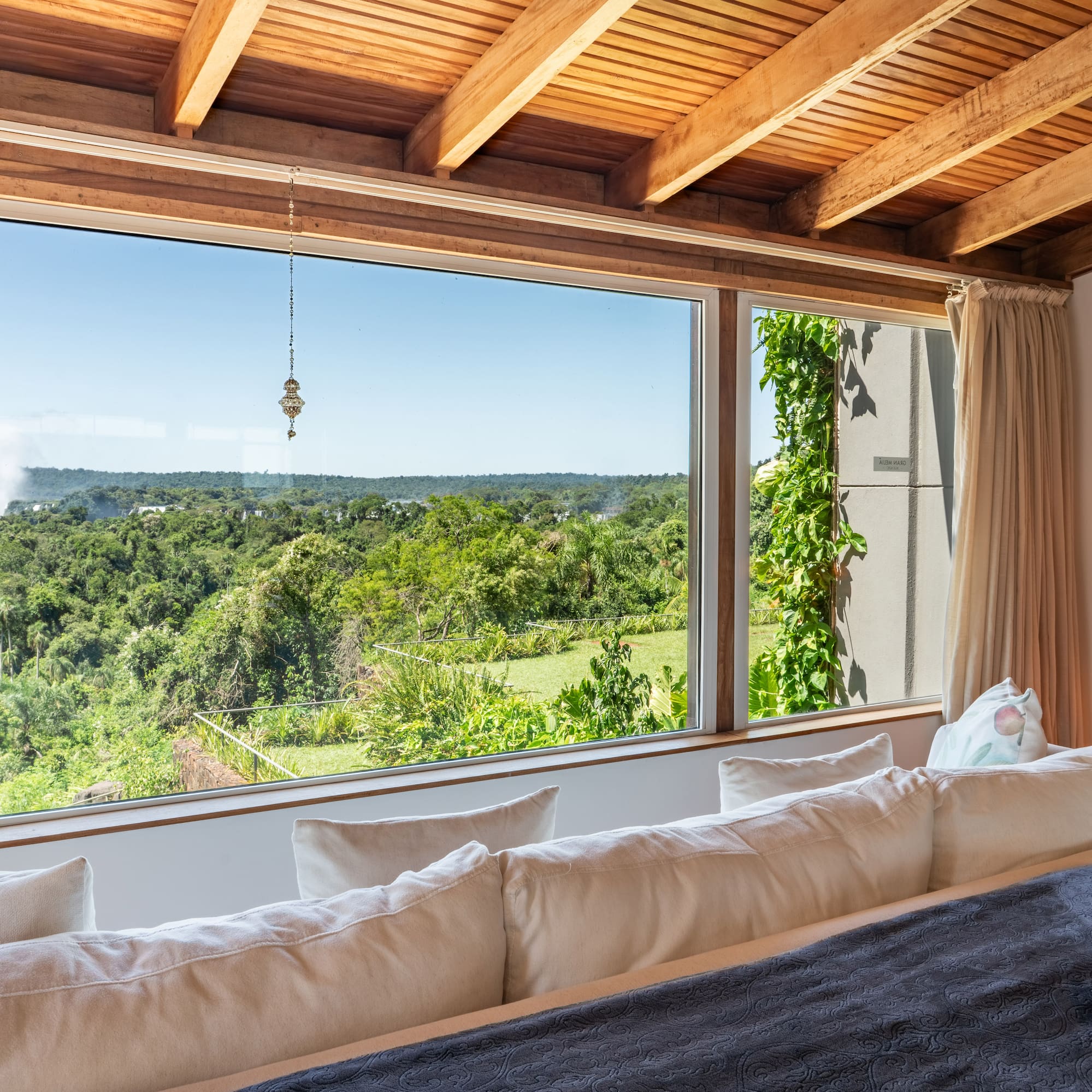 a room with a large window overlooking a forest