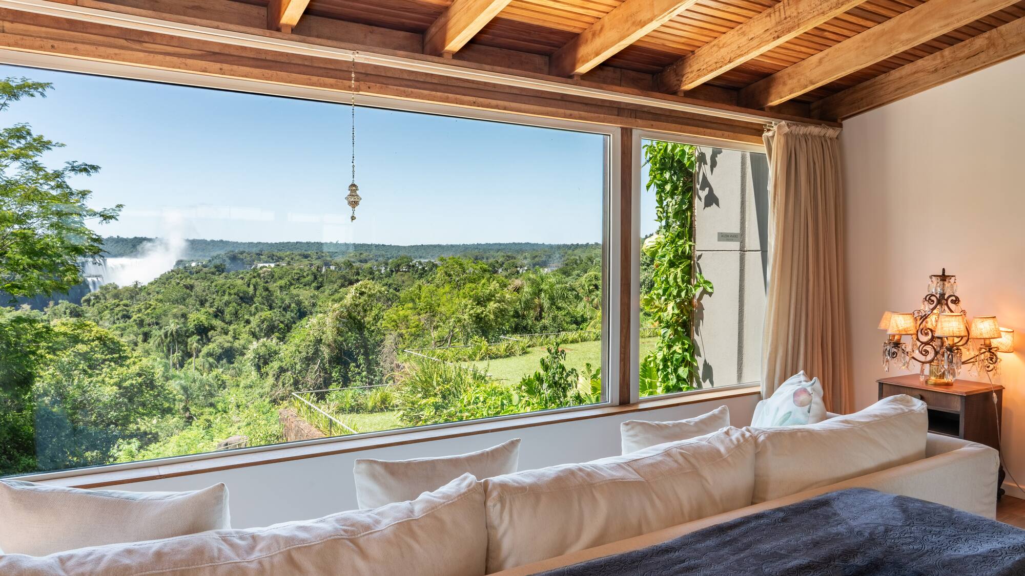 a room with a large window overlooking a forest