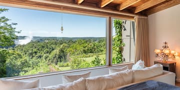 a room with a large window overlooking a forest