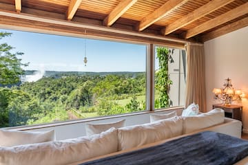 a room with a large window overlooking a forest