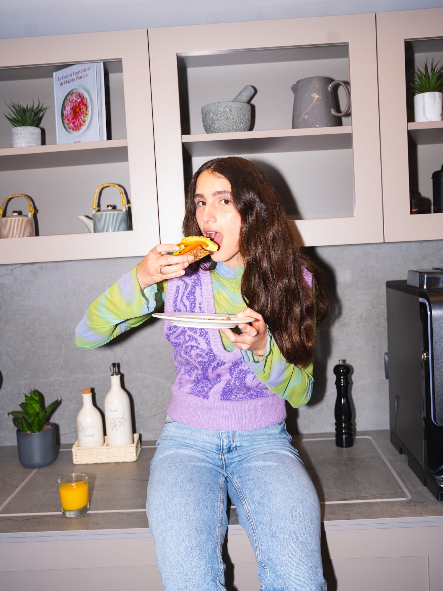 a woman eating a hot dog