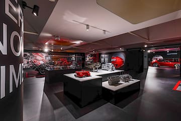 a room with a display of motorcycles