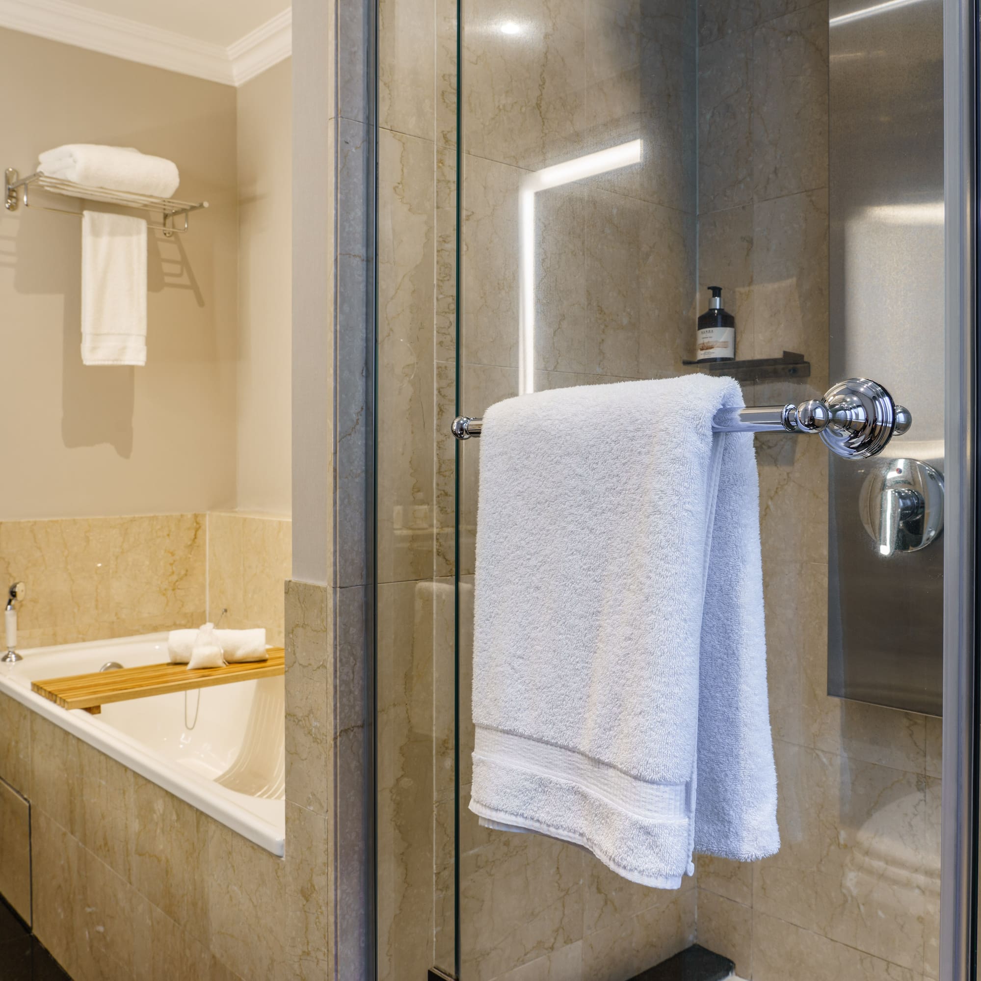 a bathroom with a glass shower door and a bathtub