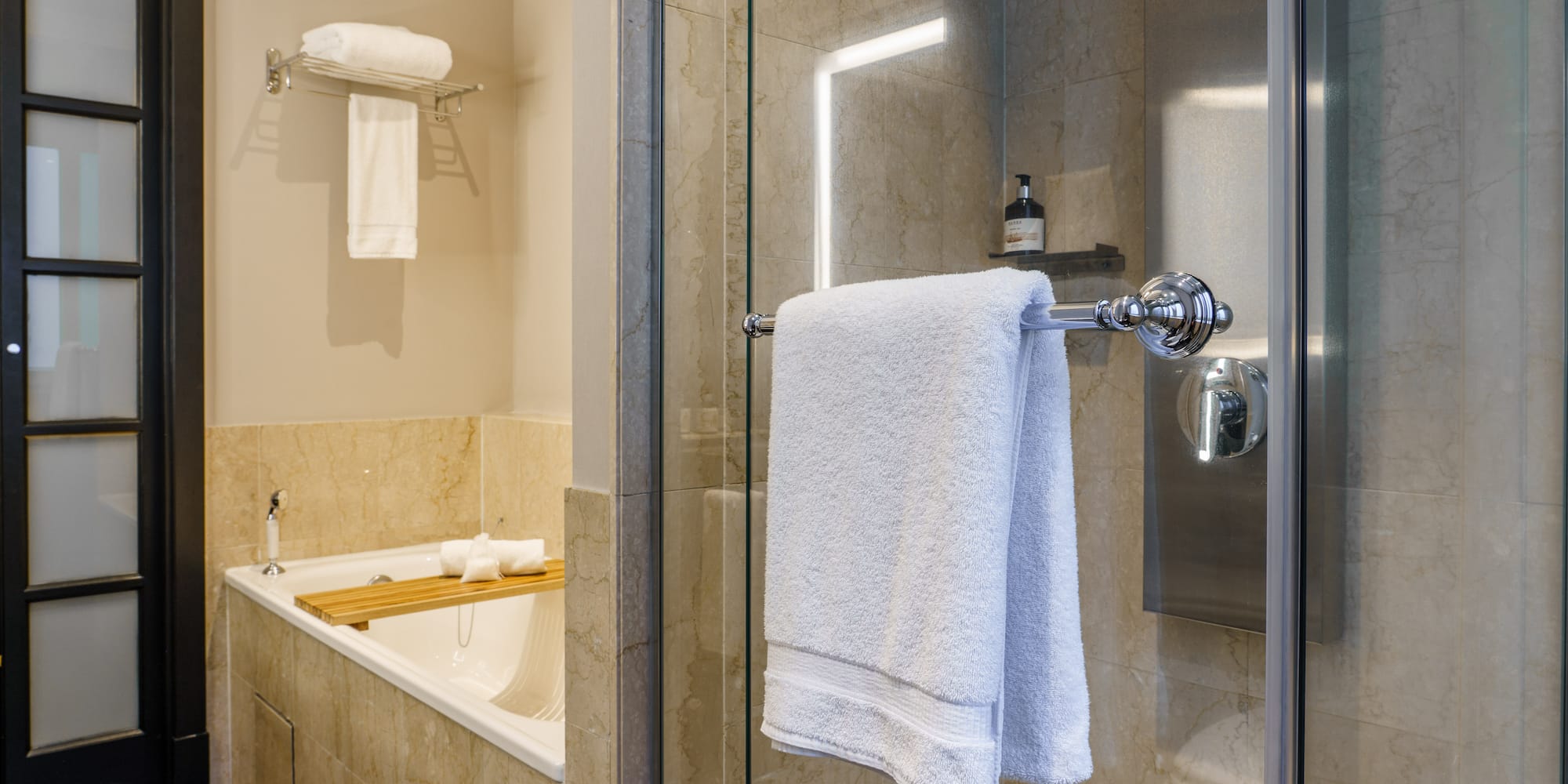 a bathroom with a glass shower door and a bathtub