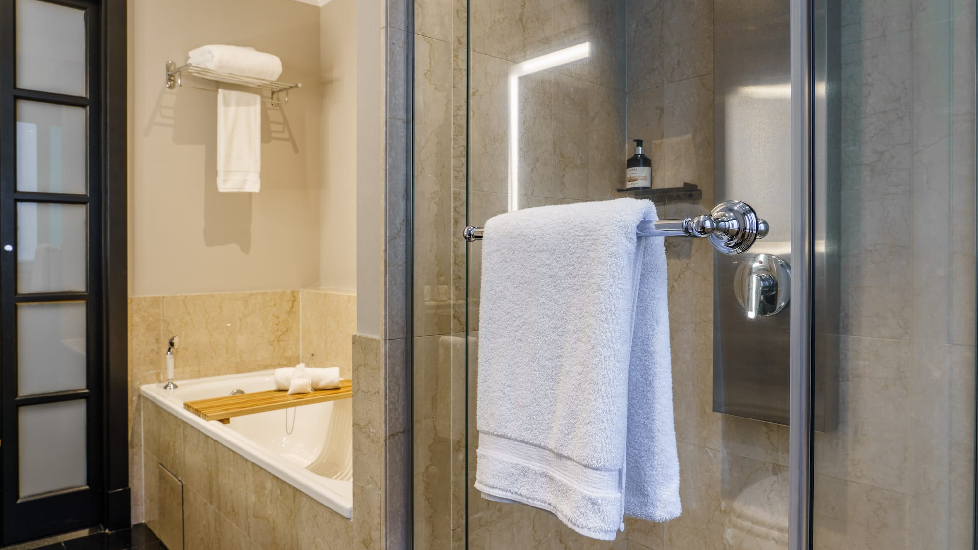 a bathroom with a glass shower door and a bathtub